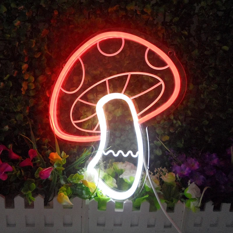 A small glowing mushroom-shaped neon sign with an acrylic backing, set against a dark background with some foliage.