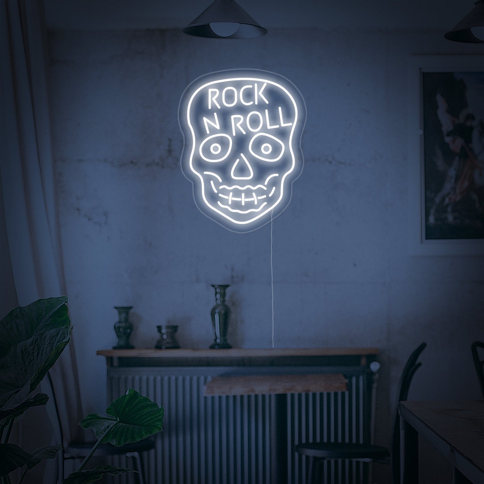 Close-up photograph of the 'Rock N Roll White Skull' neon sign, highlighting the clear acrylic backer and the crisp, white neon illumination.