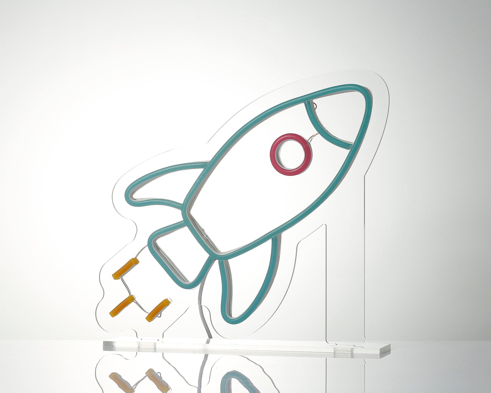 Close-up of the Rocket Desk Neon Sign showing its blue and orange glowing lines and acrylic stand