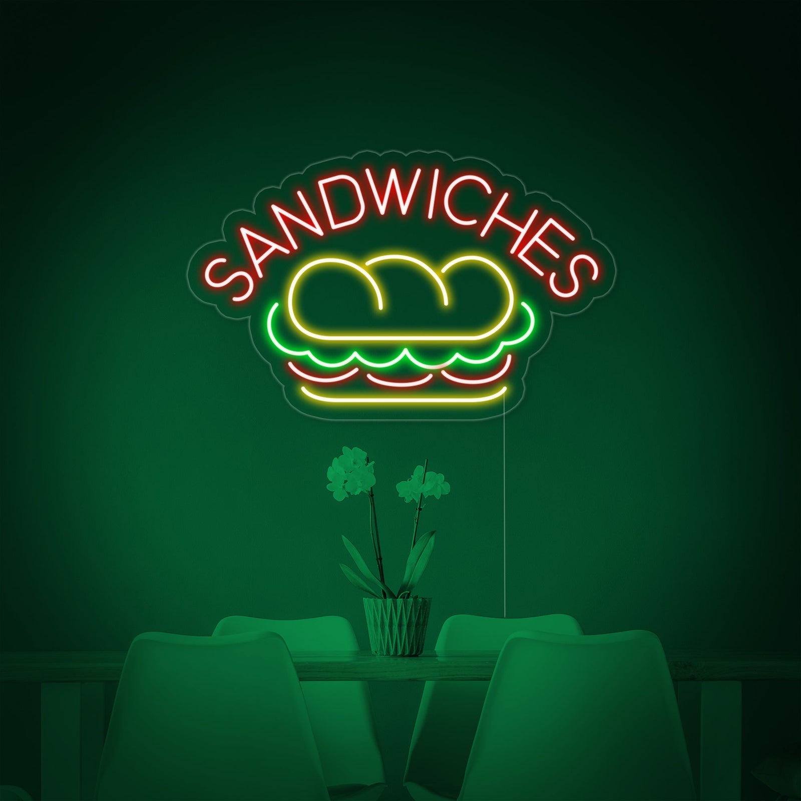 The 'SANDWICHES FOOD' neon sign glowing brightly on a wall in a monochromatic cafe setting.