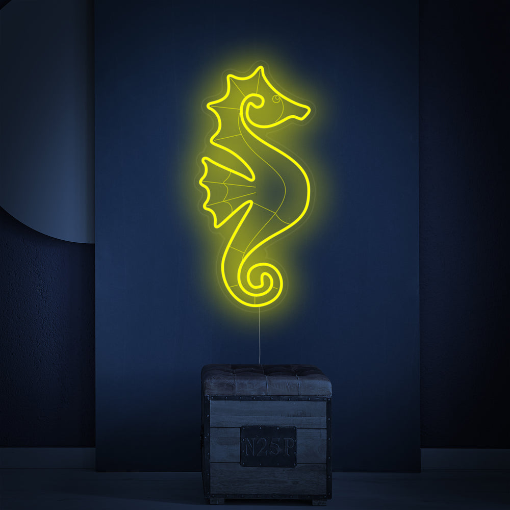 A glowing seahorse neon sign displayed on a wall above a wooden table with beach-inspired decor.