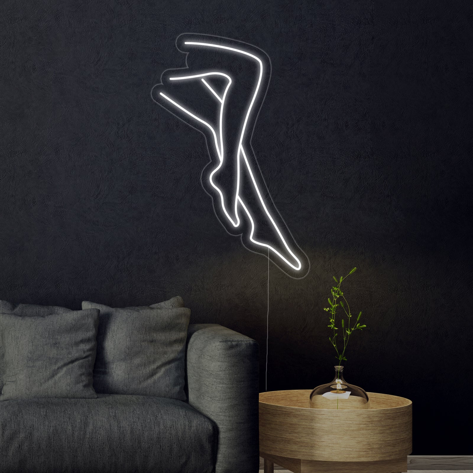 An illustrative visualization showing the "Sexy Legs Lady" neon sign with white and yellow outlines mounted above a dark modern desk and chair.
