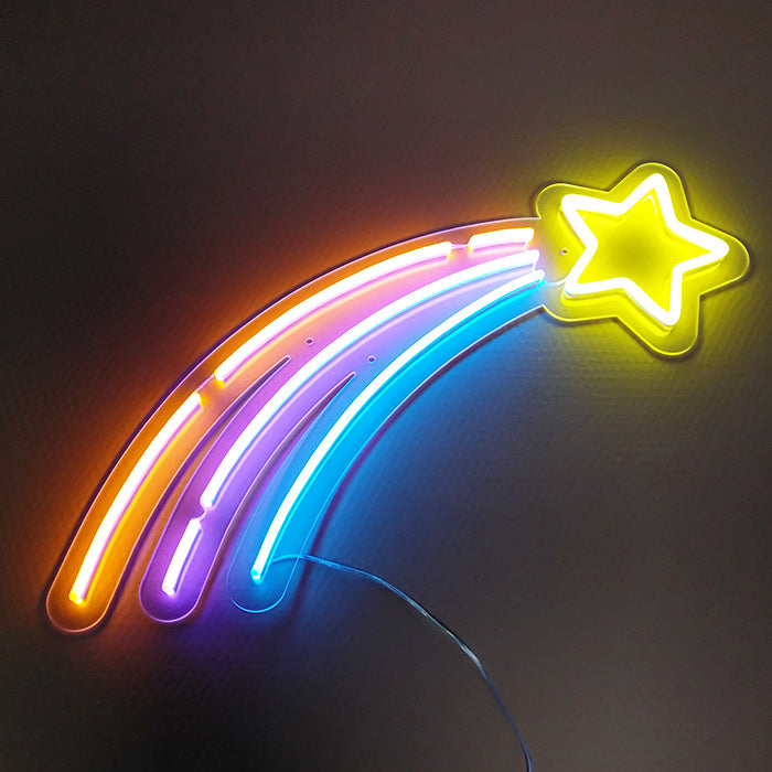 A 'Shooting Star' neon sign glowing with colorful trails and clear acrylic backing mounted on a simple wall.