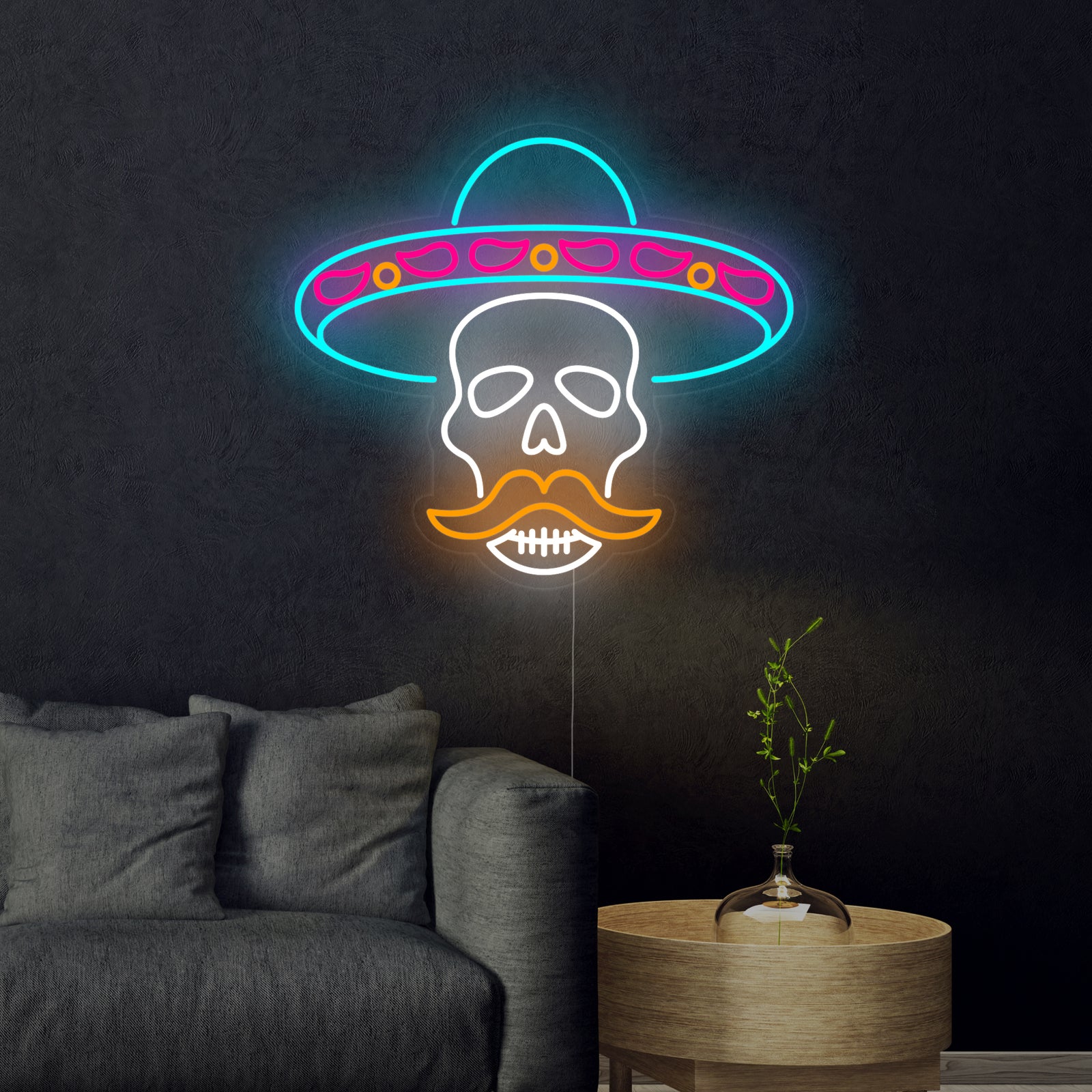 Closeup of the glowing red, orange, blue, and yellow 'Skull in Sombrero' neon sign tubing, detailed with traditional decorative patterns.