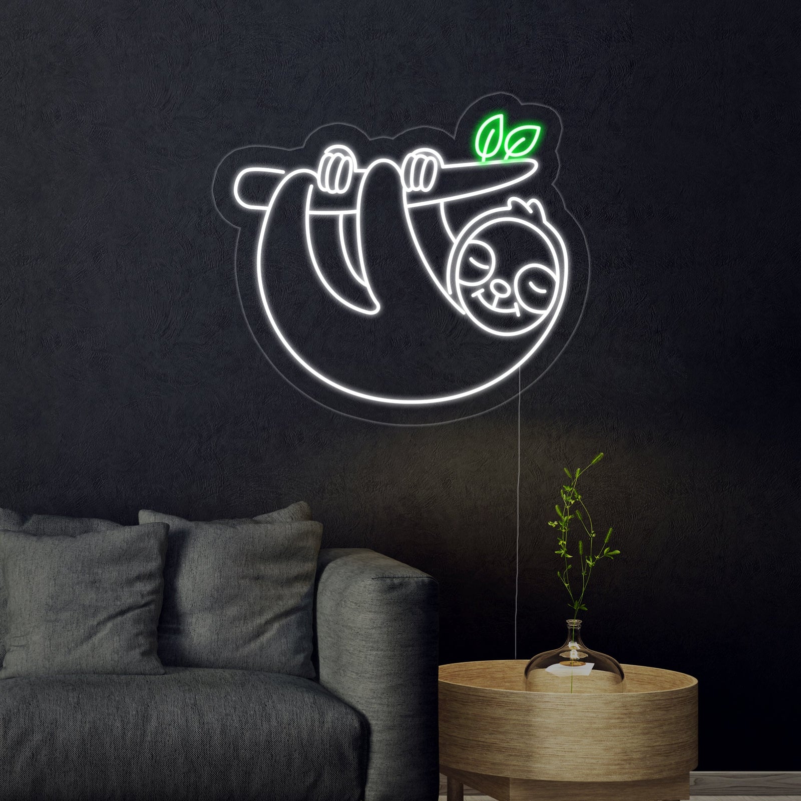 Detailed product photo of the illuminated 'Sloth' neon sign mounted on a clean white wall, showing the distinct outline and soft glow against the room background.