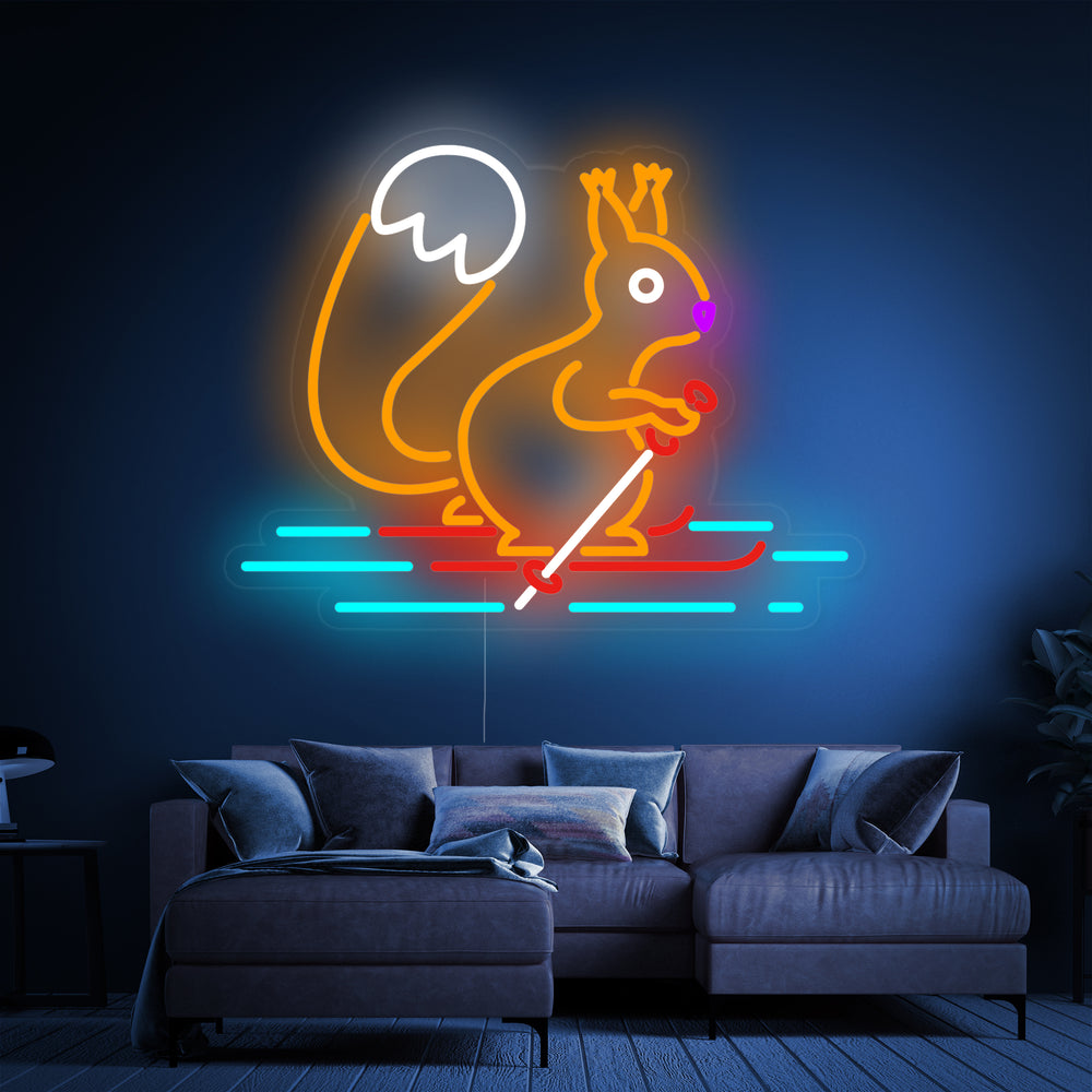 A detailed view of the 'Squirrel Skiing' neon sign, showing the playful character with skis and a beanie, mounted on a clear backing with visible mounting hardware.
