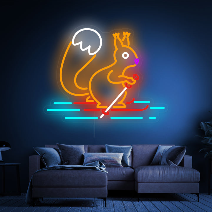 A detailed view of the 'Squirrel Skiing' neon sign, showing the playful character with skis and a beanie, mounted on a clear backing with visible mounting hardware.