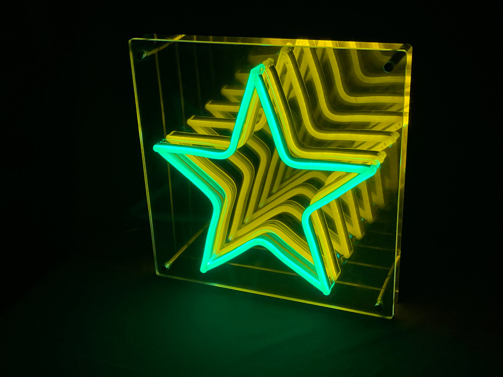 Close-up photograph of a star-shaped infinity mirror neon sign showing multiple layers of light tubes receding into depth.
