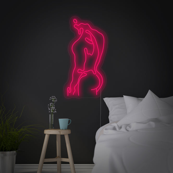 A bright red glowing neon sign depicting a muscular male physique hanging above a sofa in a modern loft apartment, highlighting its unique artistic style as a piece of glowing wall art.