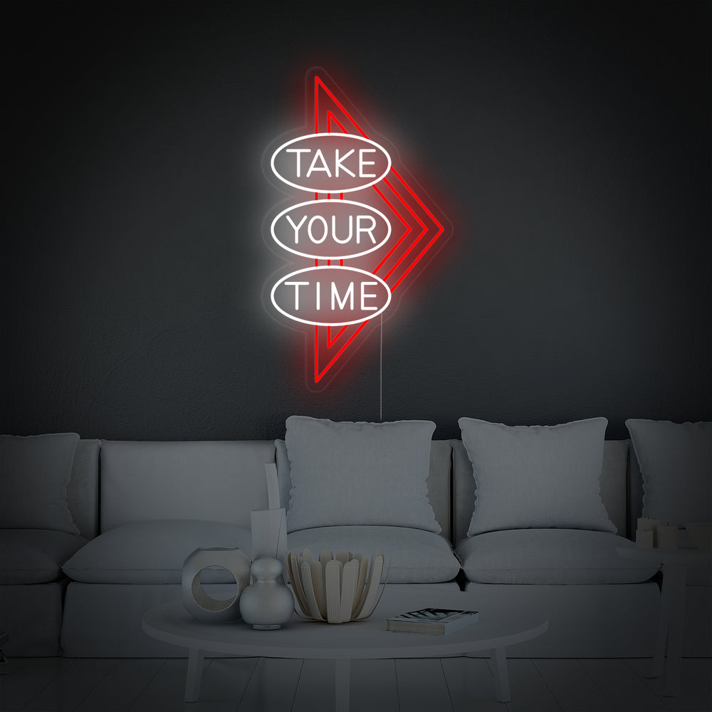 A professional product photo of the 'Take Your Time' neon sign mounted on a textured brick wall.