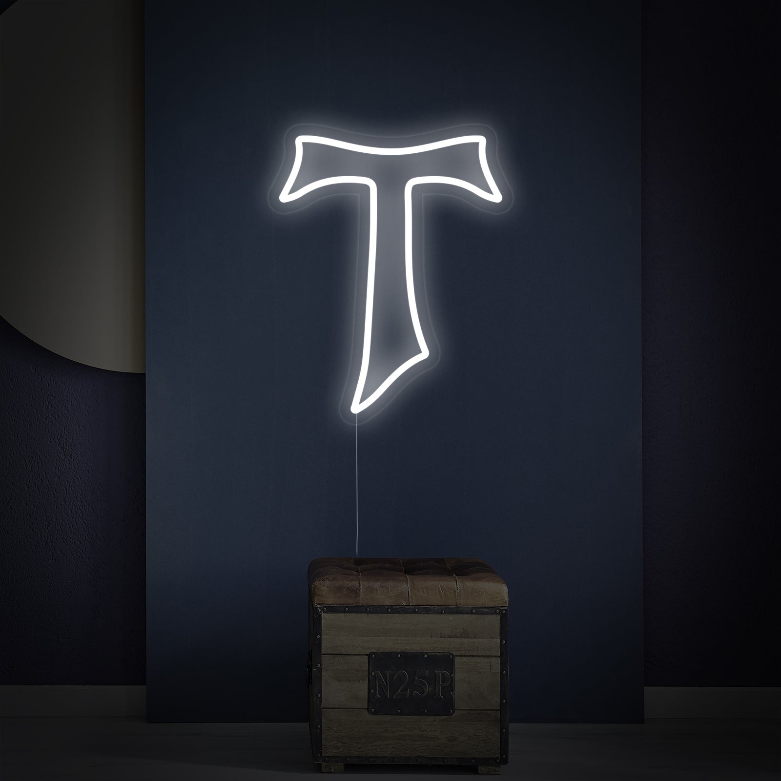 Close-up of the Tau Cross neon sign showing clear acrylic backing
