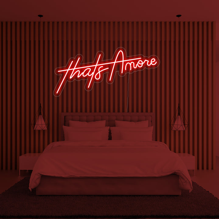 A focused shot of the 'Thats Amore' neon sign on a clear acrylic backing.