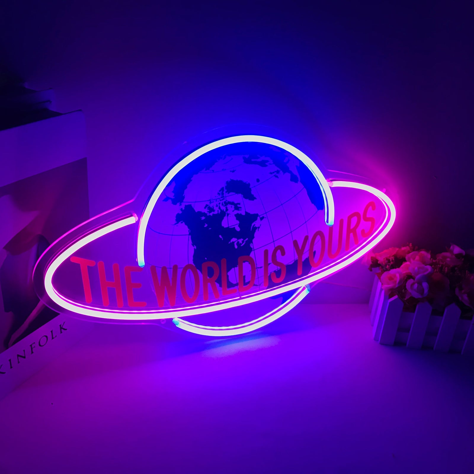 Product visualization of 'The World Is Yours' mini neon sign graphic with integrated rocket and star details.