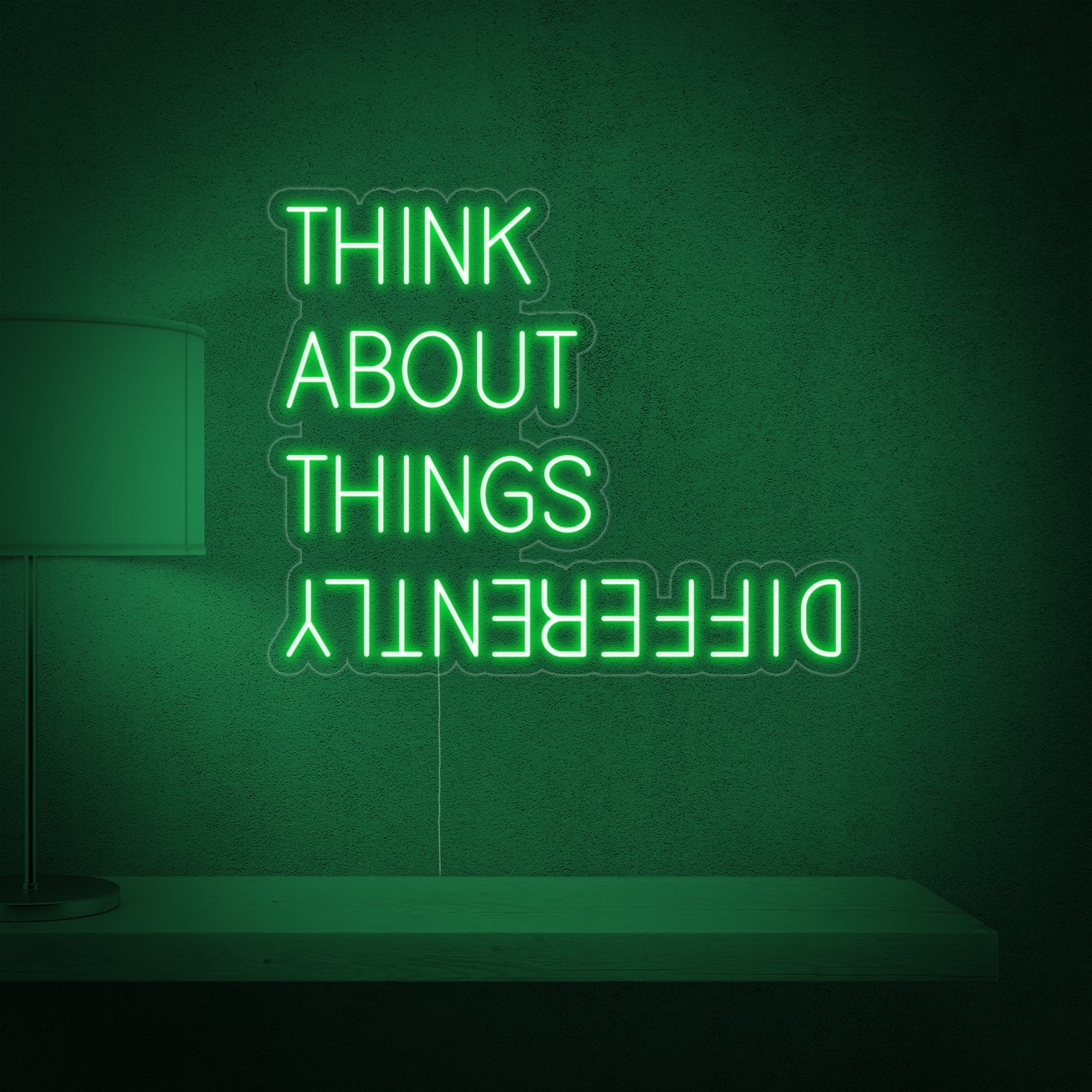 Close-up detail of the Think About Things Differently neon sign, highlighting its clear acrylic backing and illuminating light source on a white wall.
