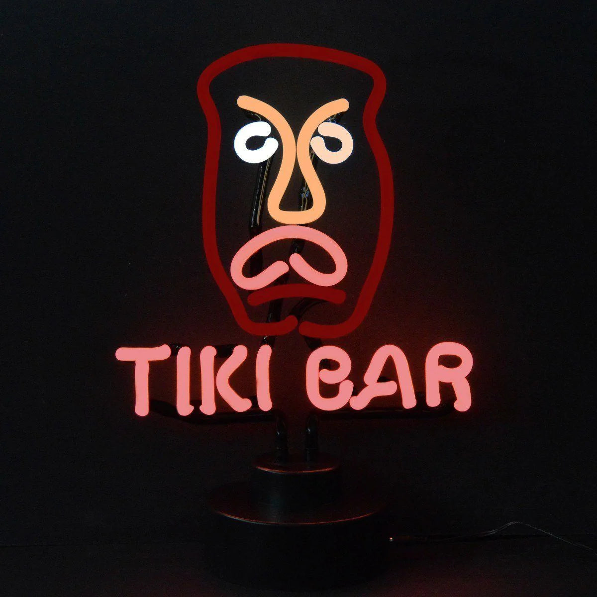 Handcrafted neon sign spelling 'Tiki Bar' with a palm tree on a dark base, displayed on a table against a light wall.