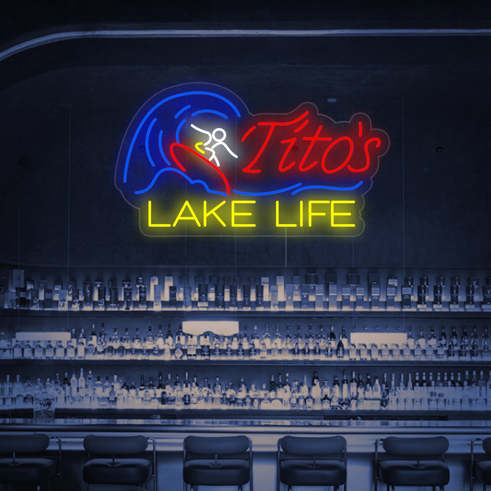 A digital product mockup of the glowing Tito's Lake Life neon sign composited onto a real photo of a lakeside bar patio.