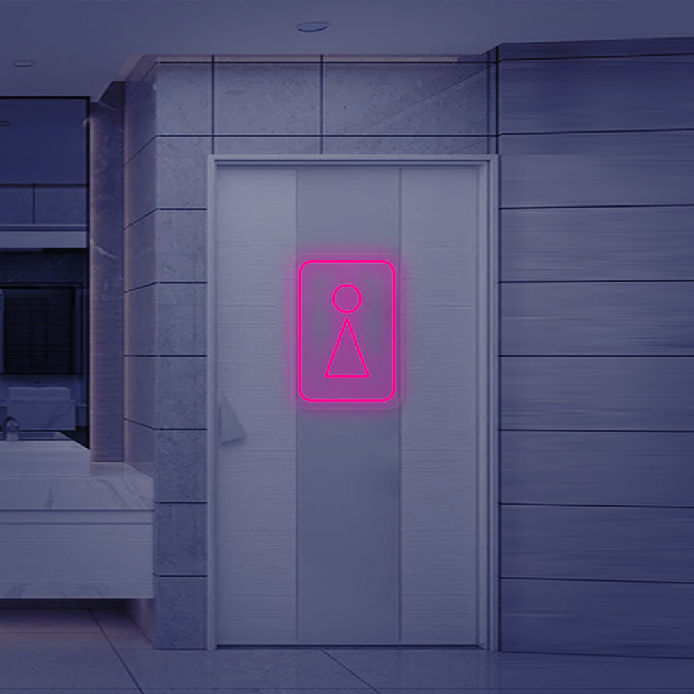 A close-up view of the 'Toilet WC Woman Symbol' neon sign, showing the detail of the luminous tubing and the classic female pictogram design.