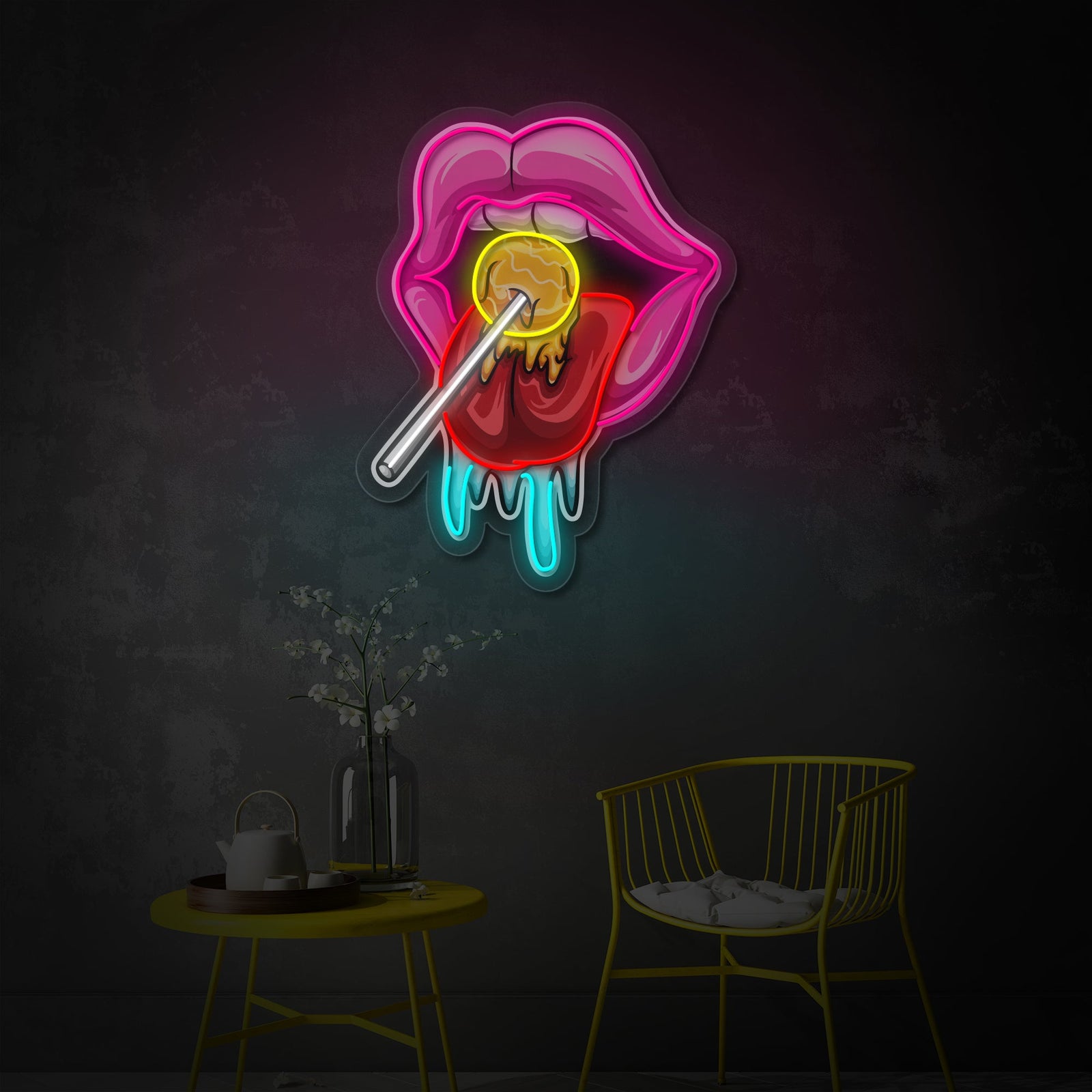 A close-up photograph of a brightly lit neon sign featuring a stylized tongue reaching for a colorful lollipop, mounted on a clear acrylic backing against a blurred background.