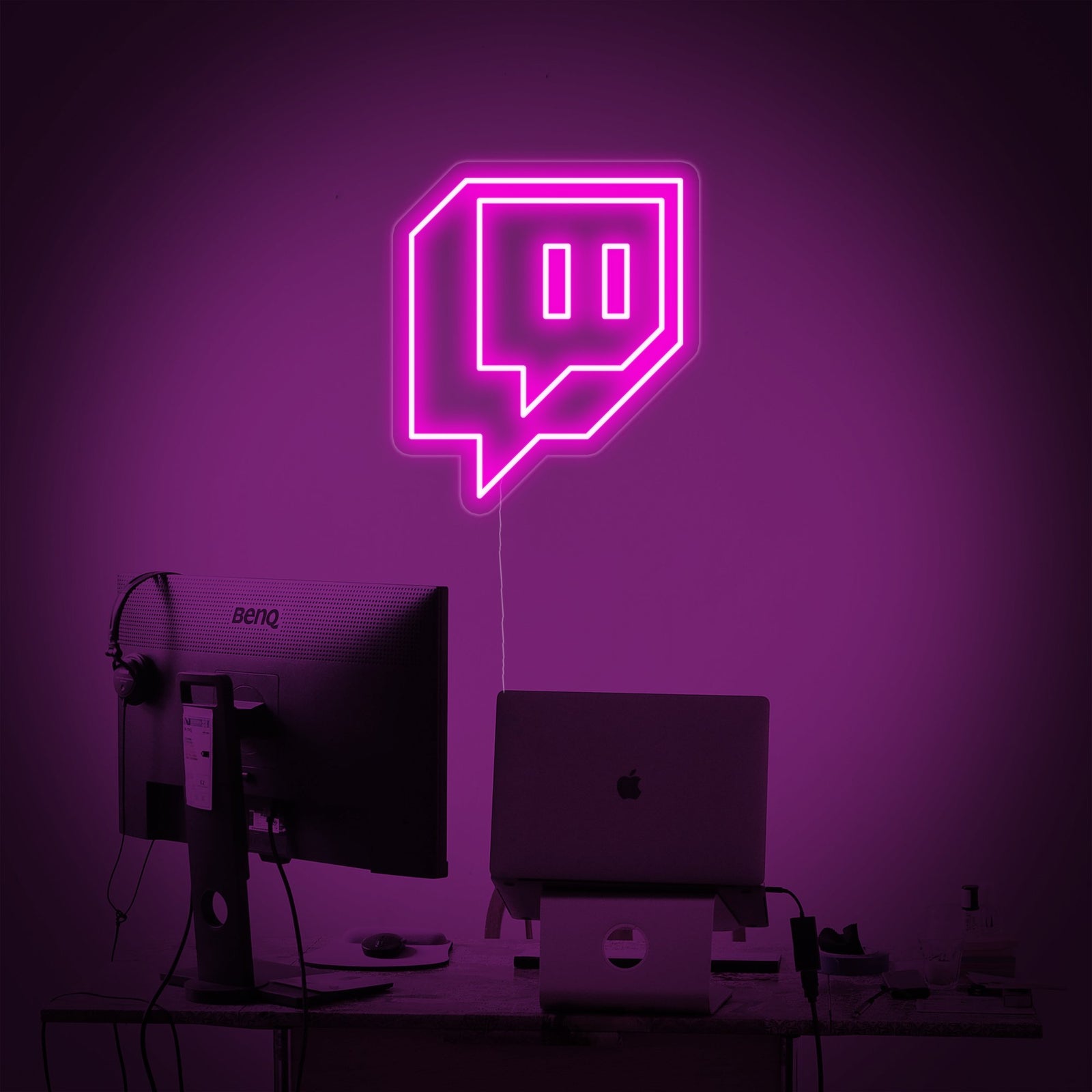 Closeup photograph of a fabricated Twitch logo neon sign on clear acrylic backing, showing the tubing details.