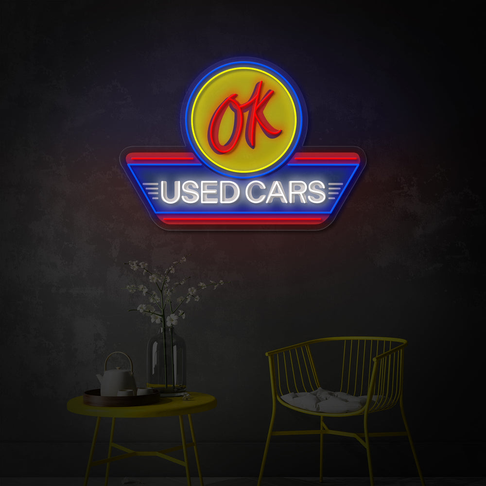 Close-up detail of the 'Used Cars' and 'Auto Service' text and logo on the neon wall decor