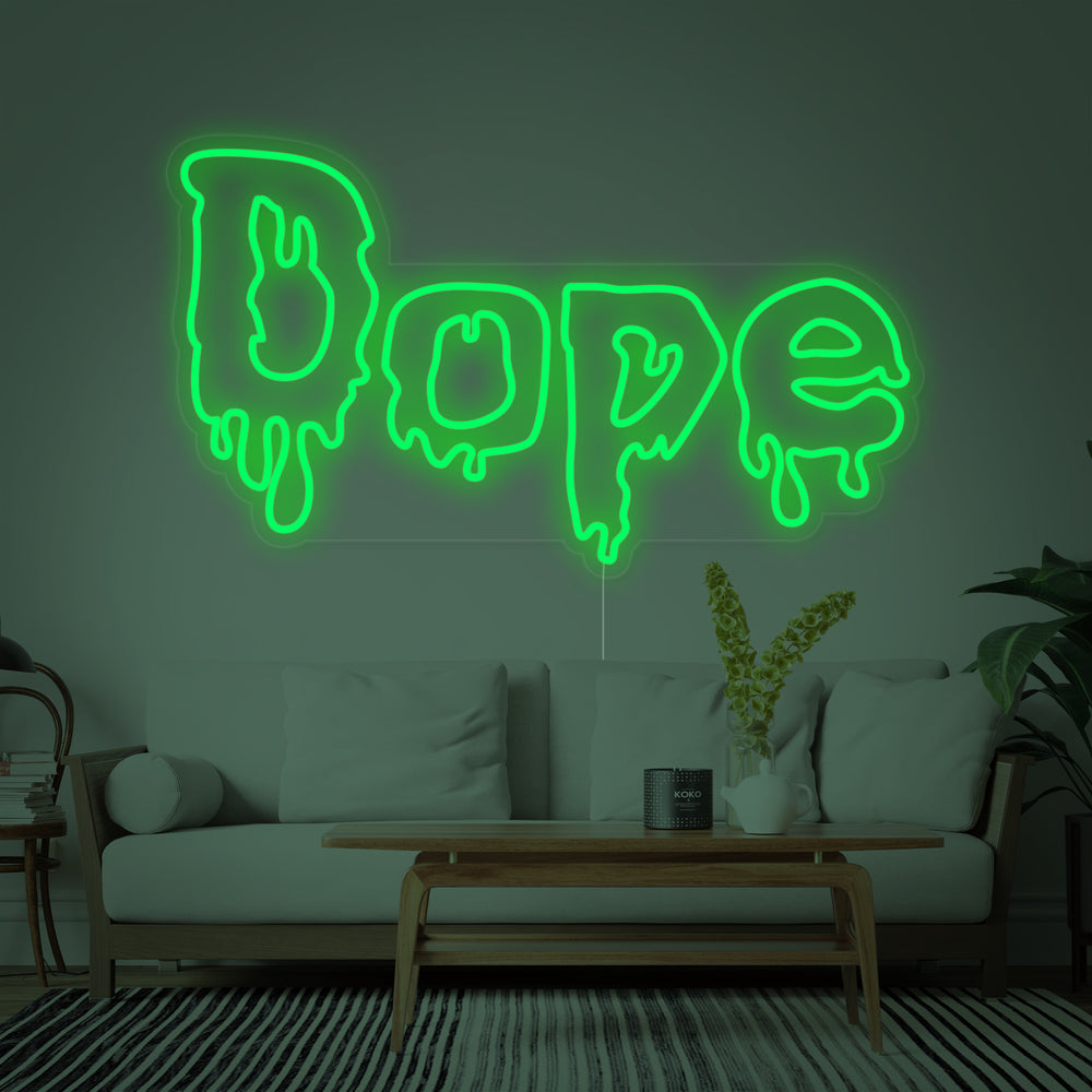 Idealized mockup photo of the "Dope" cannabis neon sign glowing brightly on a textured grey concrete wall, showcasing its stylized script and leaf design for interior decor inspiration.
