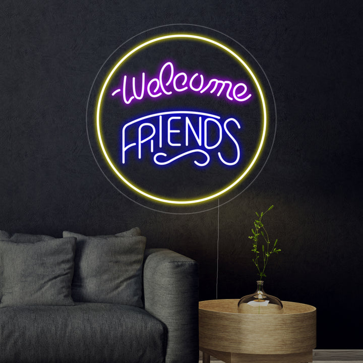 The 'Welcome Friends' neon sign glowing brightly in blue cursive script on a light wooden background.