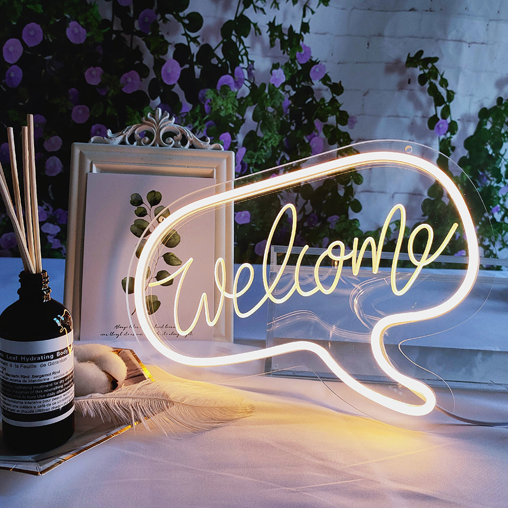 A glowing 'Welcome' USB mini neon sign with white 3D letters and a light blue outline on an acrylic backing.
