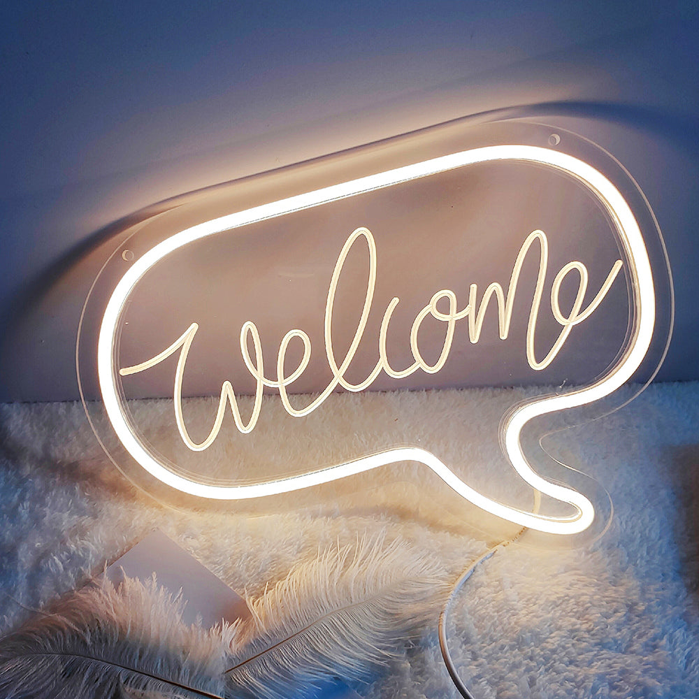 An unlit 'Welcome' mini neon sign with white 3D letters on clear acrylic, showing the power cable attachment.