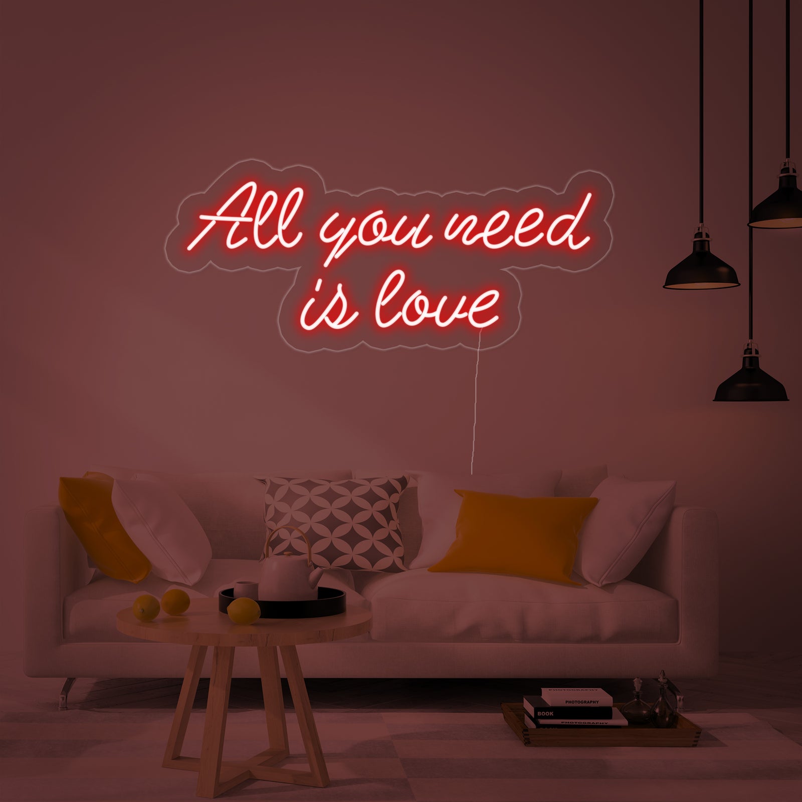 Close-up of the lit 'All You Need is Love' neon sign showing the distinct glowing tubes and backing plate.