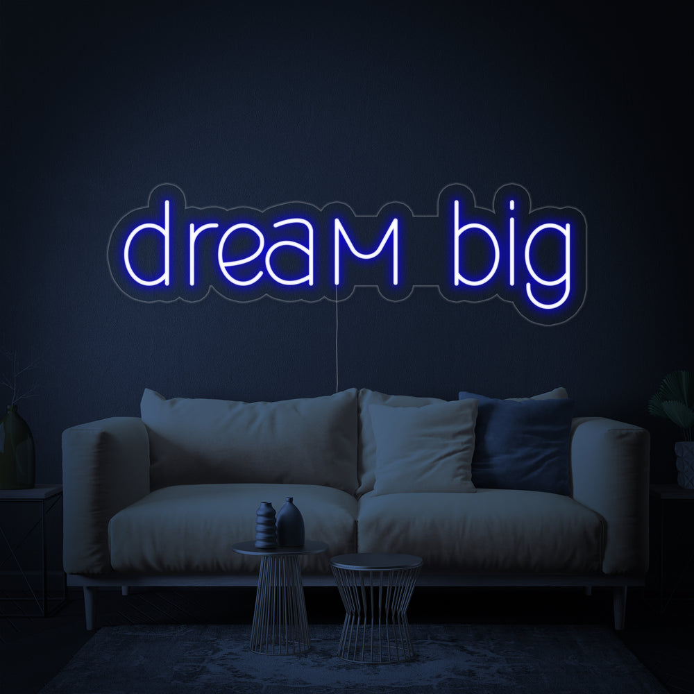 Close-up of the glowing "Dream Big" neon sign design against a dark blue textured background