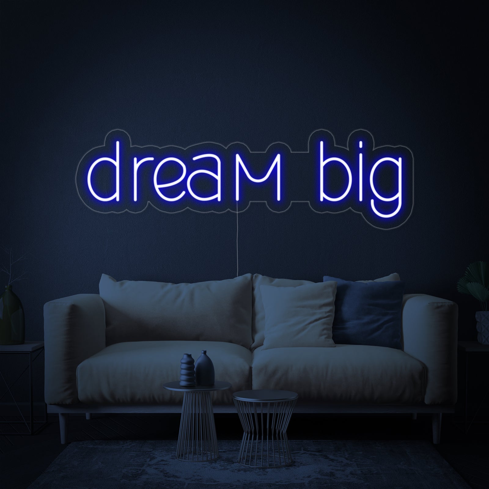 Close-up of the glowing "Dream Big" neon sign design against a dark blue textured background