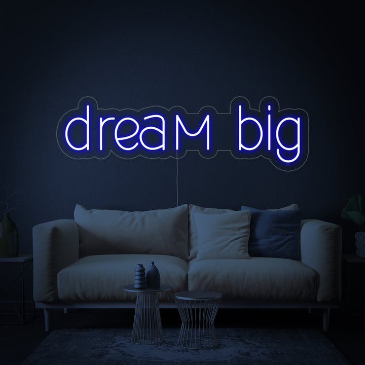 Close-up of the glowing "Dream Big" neon sign design against a dark blue textured background