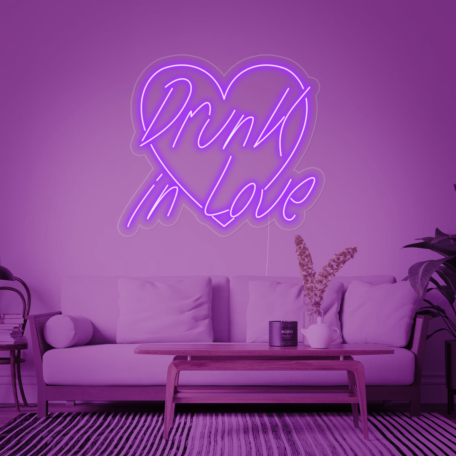 A 'Drunk In Love' neon sign glowing brightly in a modern living space.
