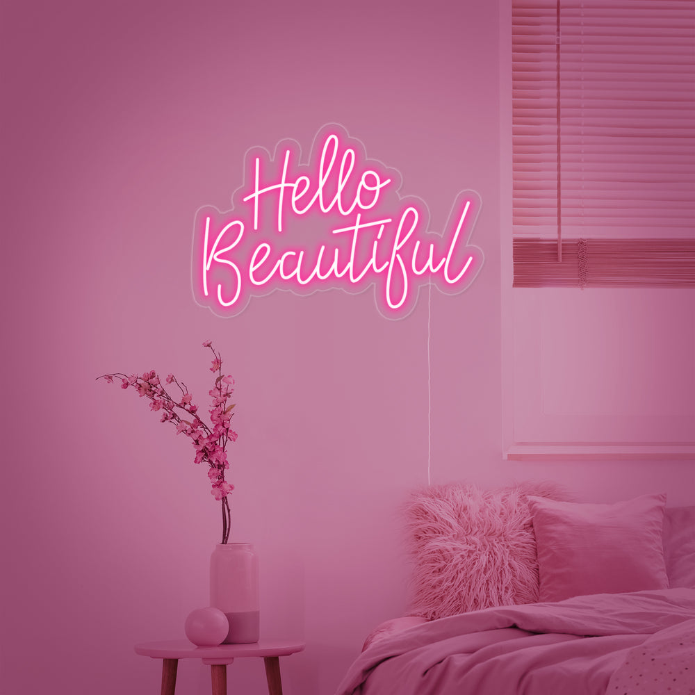 Close-up of the 'Hello Beautiful' neon sign with clear acrylic backing and power cord visible