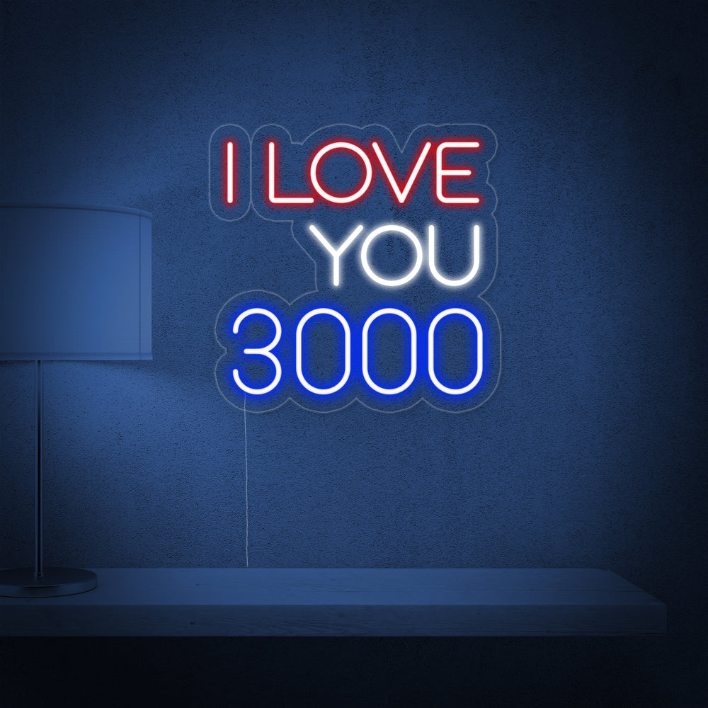 A glowing 'I Love You 3000' neon wall sign mounted above a shelf with a lamp, providing warm accent lighting.