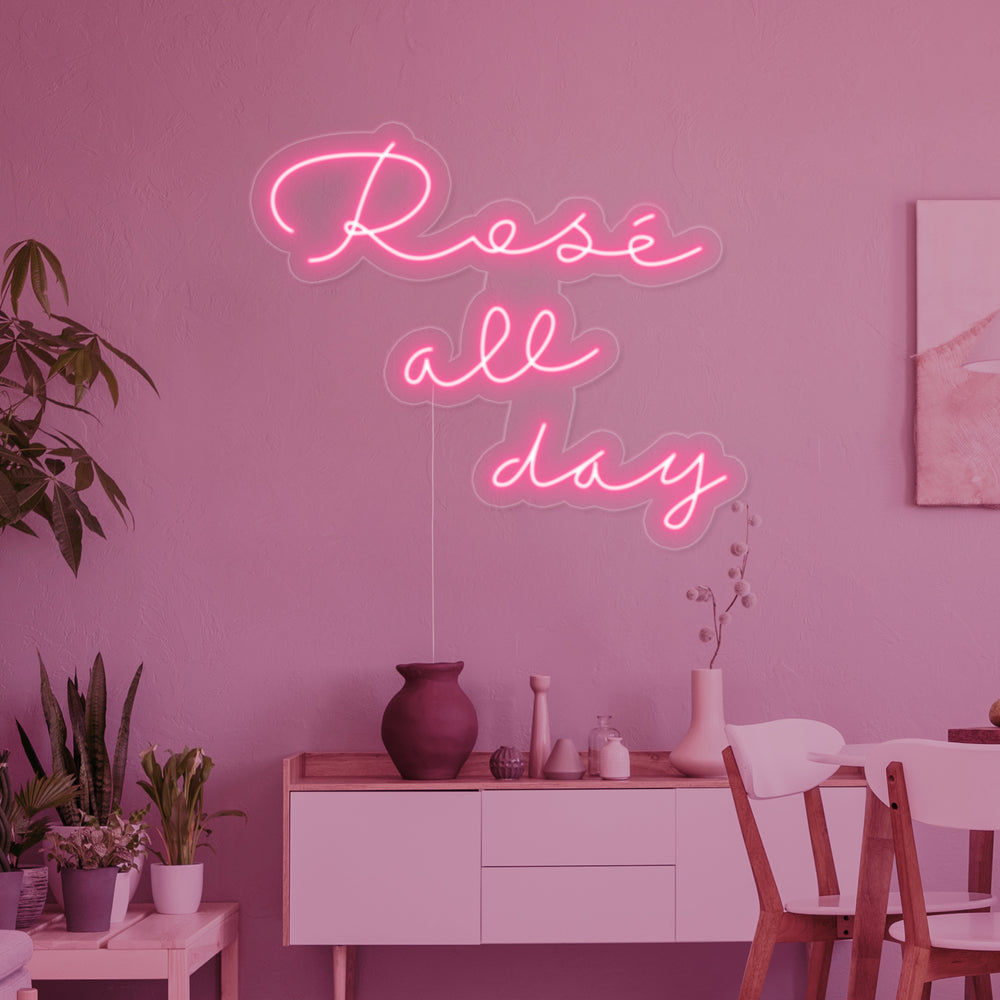 Close-up detail of the "Rose All Day" neon sign showing the clear acrylic backing.